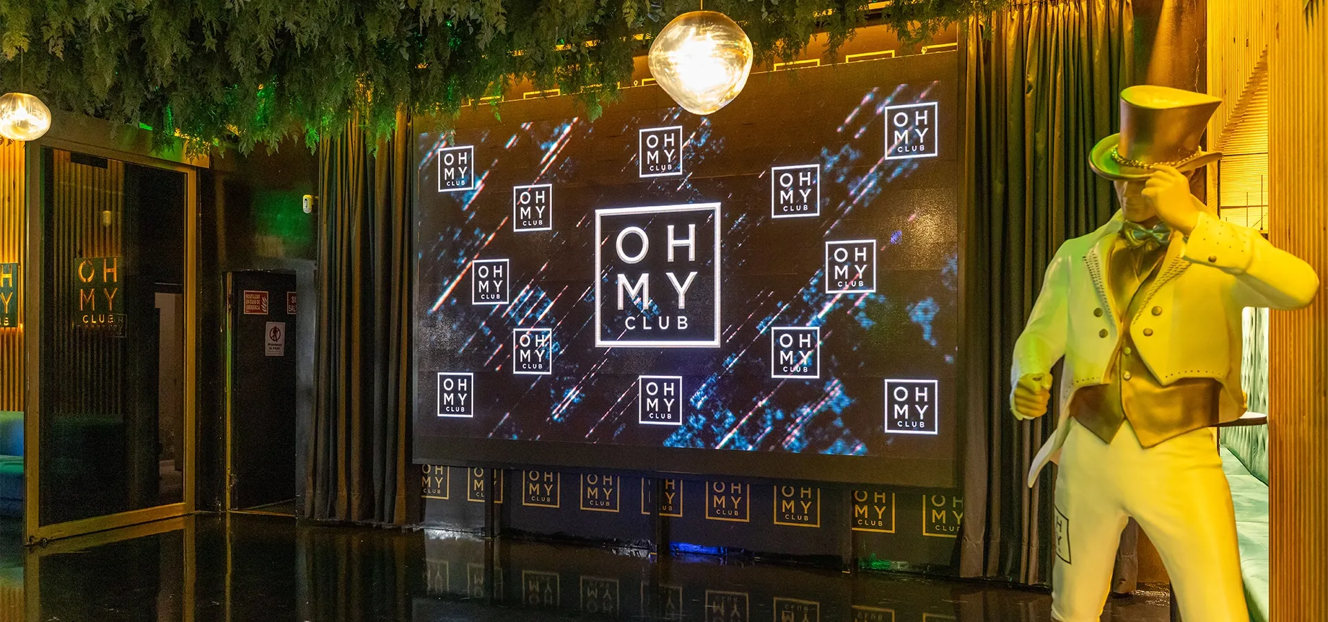 Main entrance with illuminated logo at Oh My Club Madrid