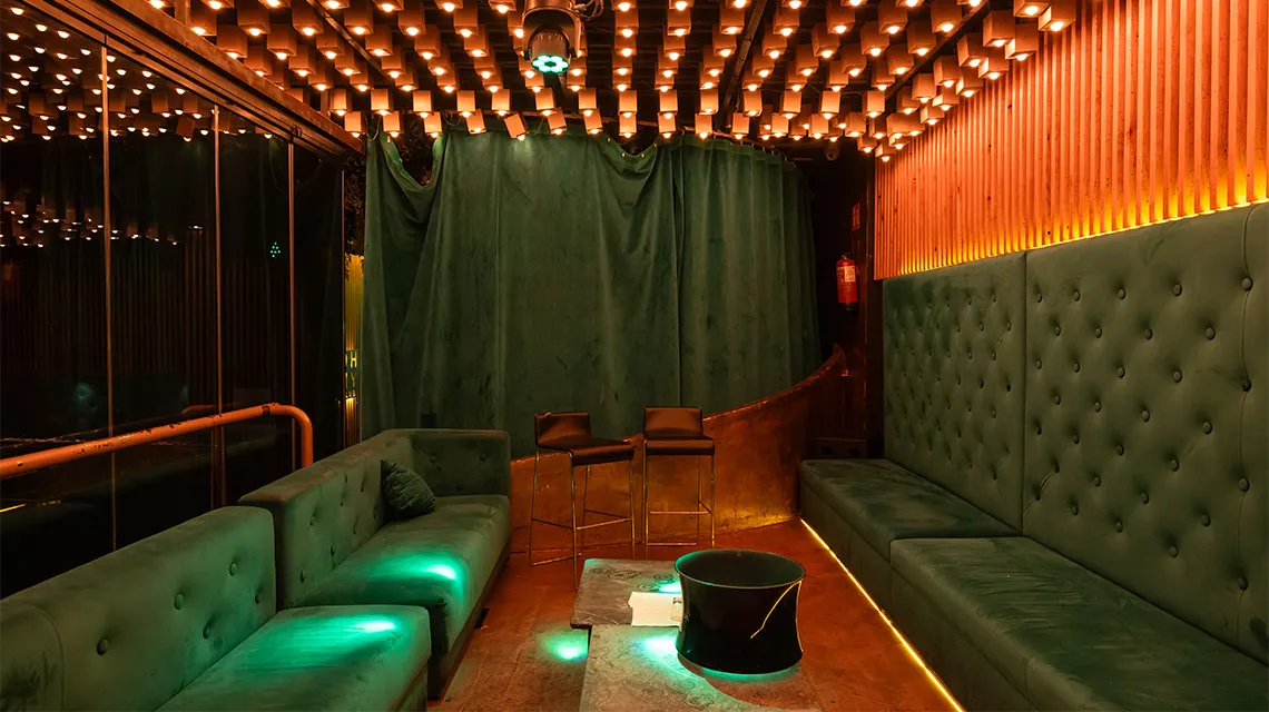 Garden VIP booths with upholstered benches at Oh My Club Madrid