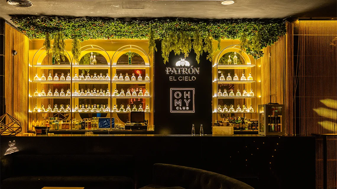 Onix room bar with illuminated shelves at Oh My Club Madrid